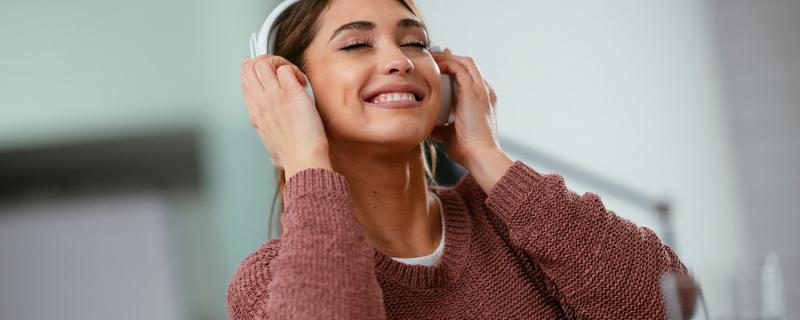 woman listening to music at desk